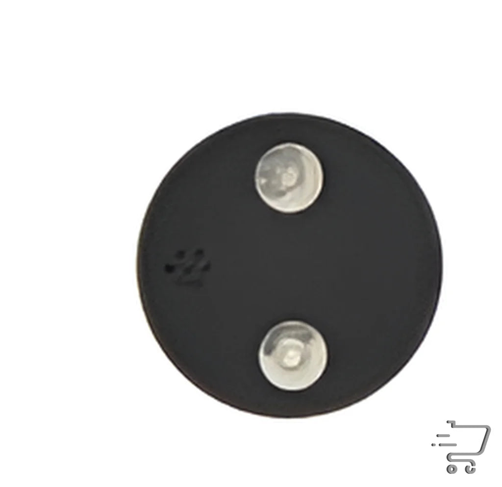 Circular black electronic pulse massager part with two silver screws and a round hole