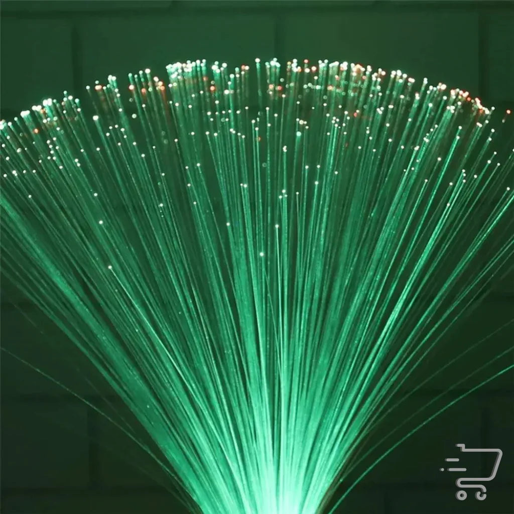 Bundle of illuminated green fiber optic strands fanning outward for enchanting lighting