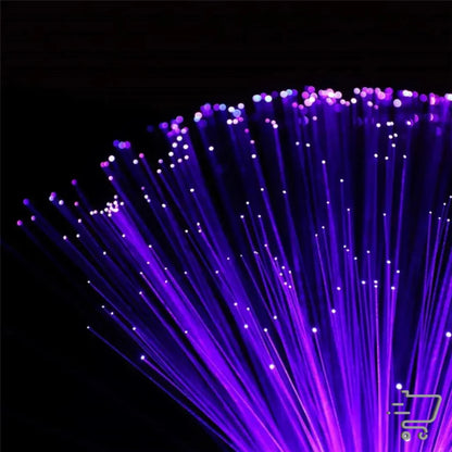 Bundle of illuminated purple fiber optic strands spreading against a dark background