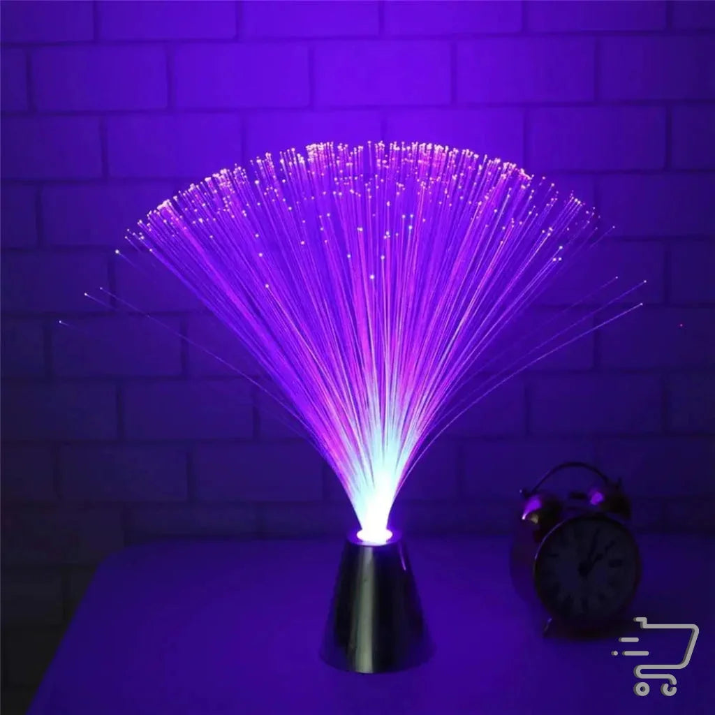 Fiber optic lamp emits vibrant purple light in a fan-like spray pattern for enchanting decor