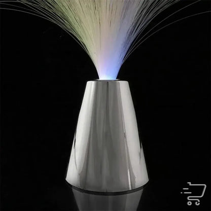 Metallic conical device emitting colorful fiber optic strands for enchanting lighting